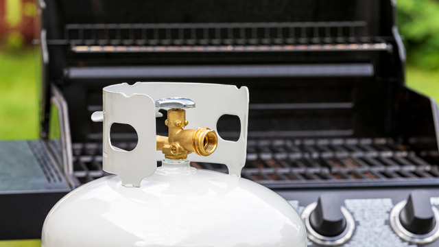 Propane tank in front of a grill